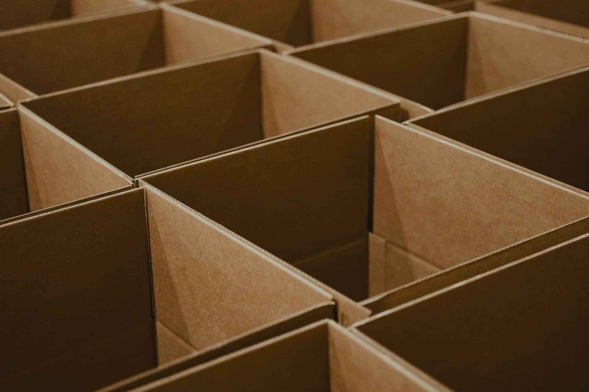 A grid of open, empty cardboard boxes, ready for a clean move.