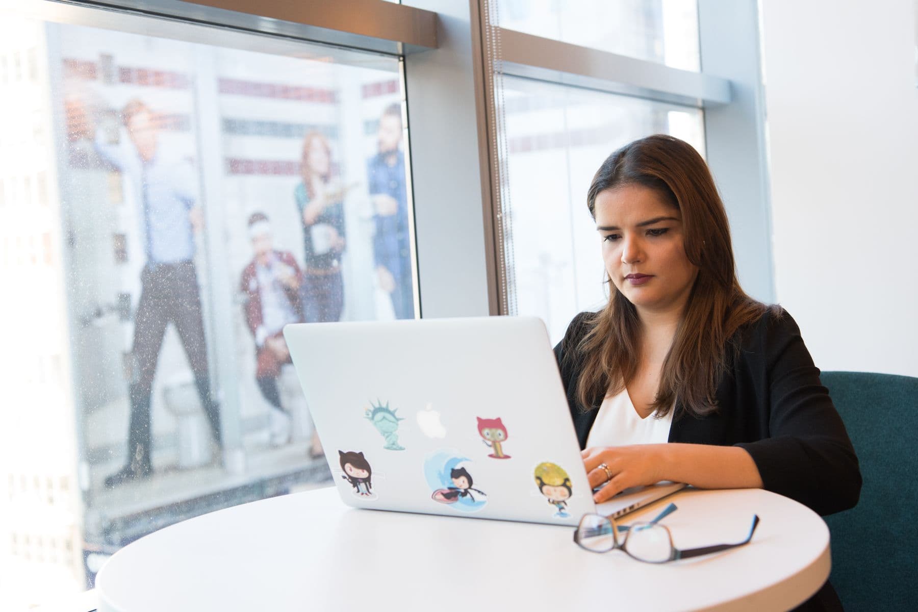 A product professional using analytics on a laptop in a modern workplace