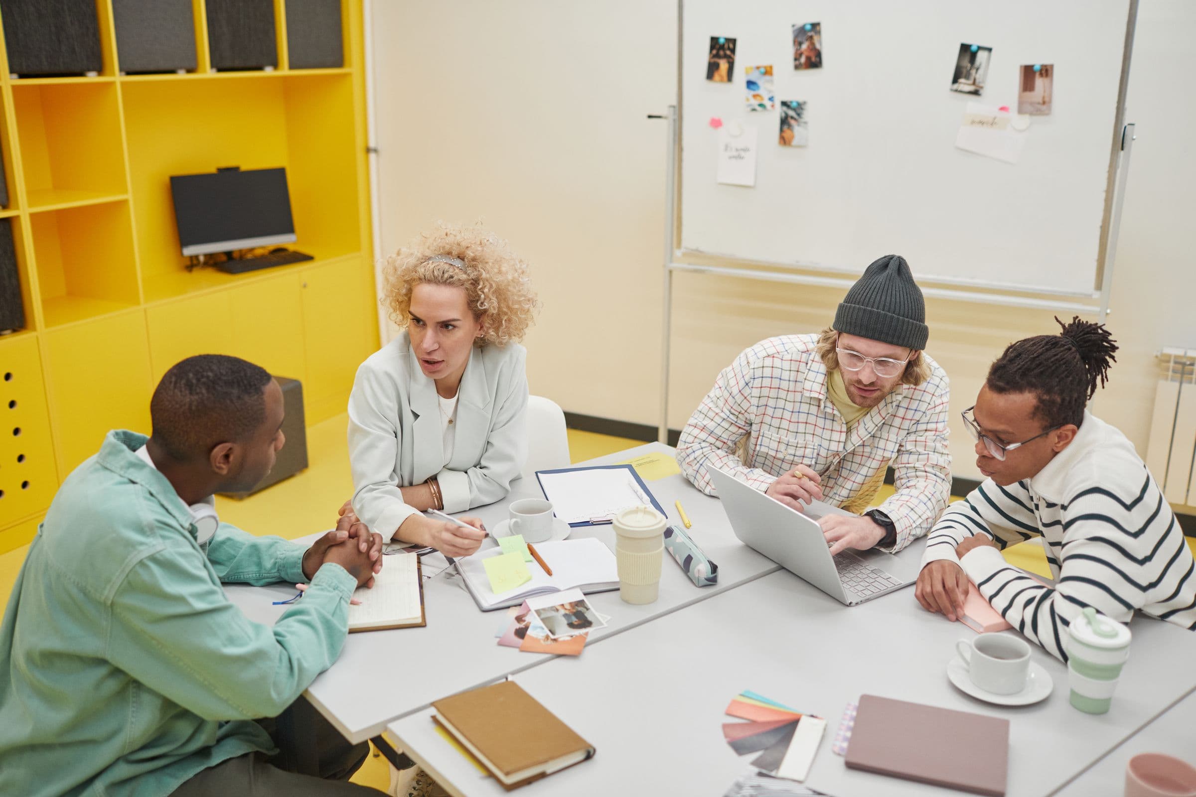 Agency team planning client work together in a bright creative studio